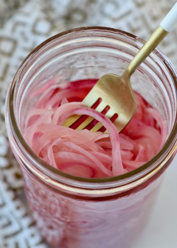 pickled onions in mason jar with fork