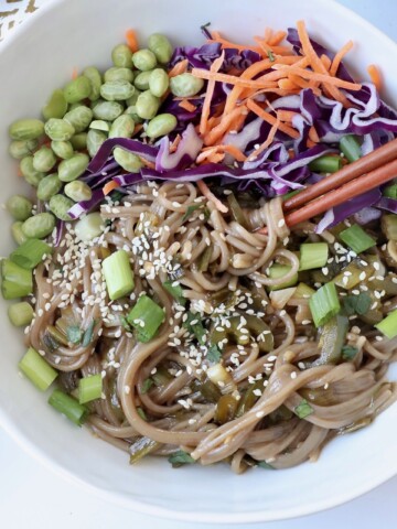 sesame soba noodles in bowl with chopsticks