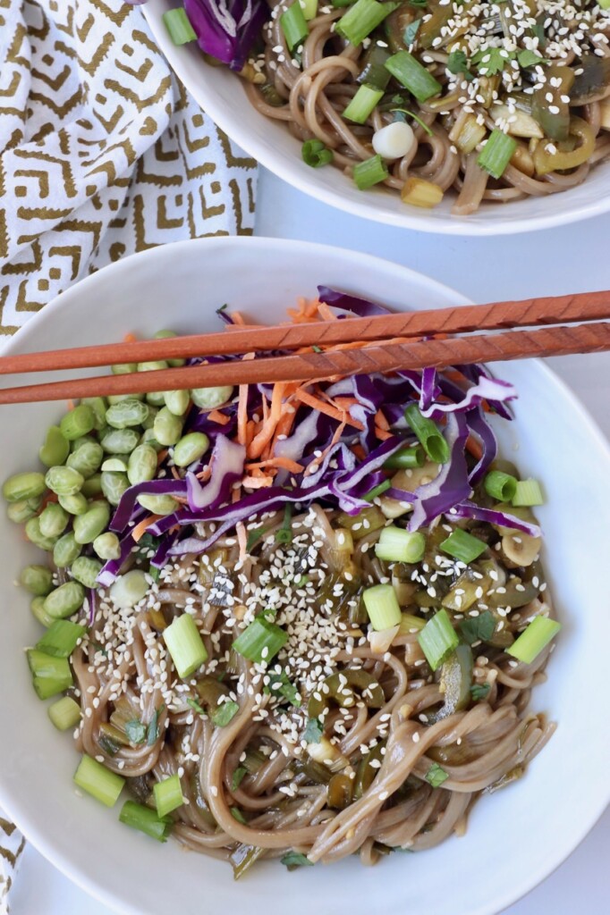 cooked soba noodles in bowl with vegetables and diced green onions