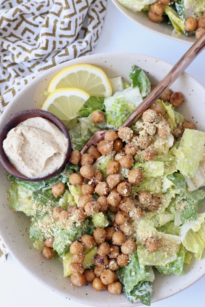vegan caesar salad topped with chickpeas in bowl