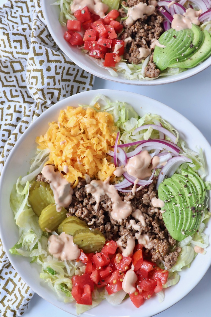 burger in a bowl with cooked ground beef, cheese and vegetables