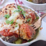meatball on fork in bowl with melted mozzarella cheese over meatballs and spaghetti squash