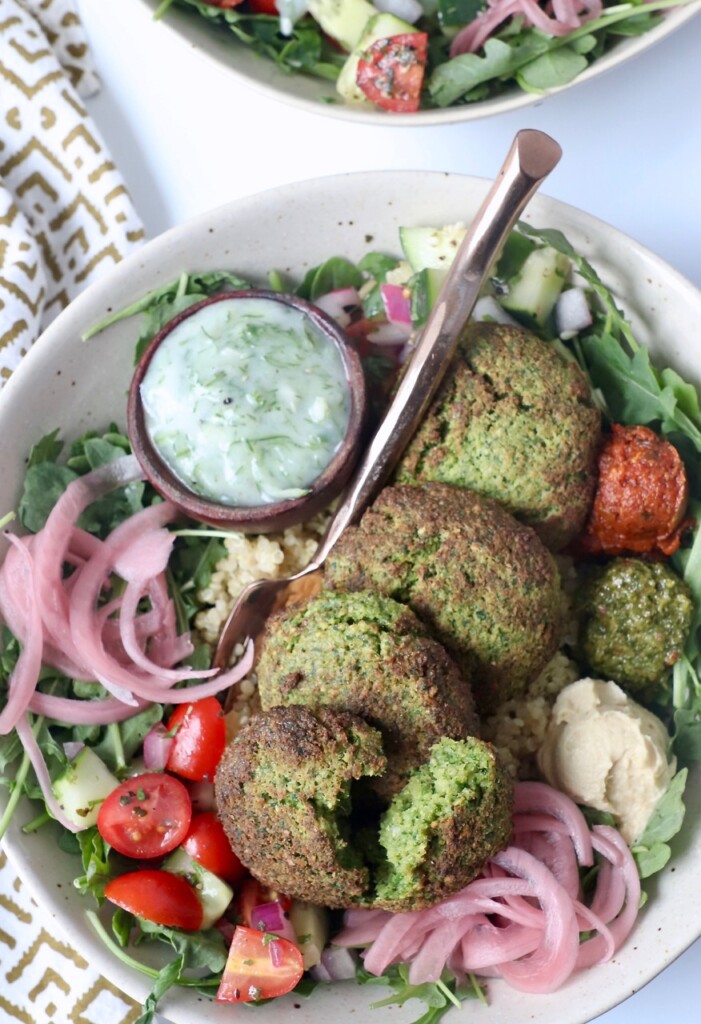 air fryer falafel in bowl with vegetables and tzatziki sauce