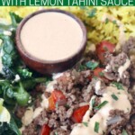 cooked ground beef, rice and vegetables in bowl with tahini sauce