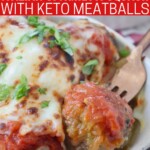 meatball on fork in bowl with spaghetti squash, marinara sauce and melted cheese