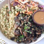 cooked mushrooms in bowl with cooked quinoa, coleslaw and peanut sauce