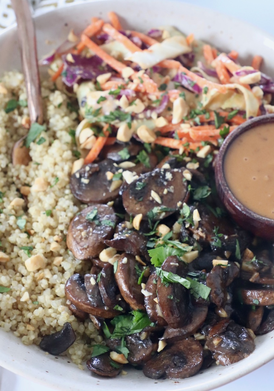 cooked mushrooms in bowl with quinoa and slaw