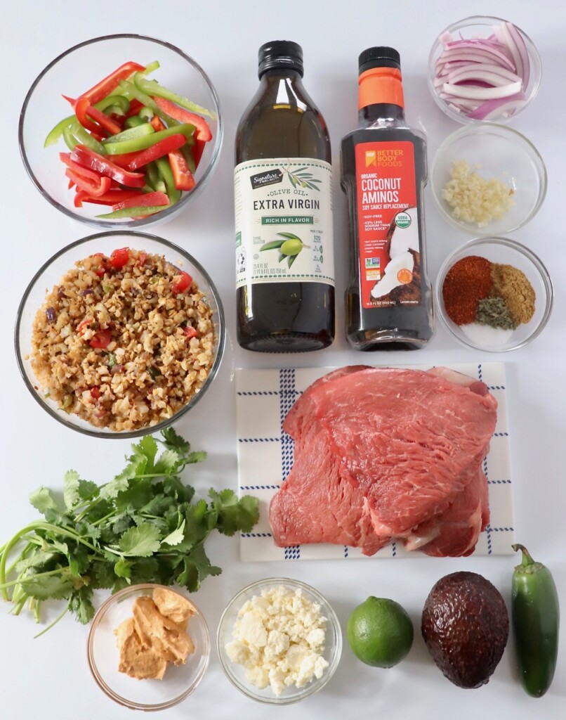 ingredients for steak burrito bowl displayed on white board