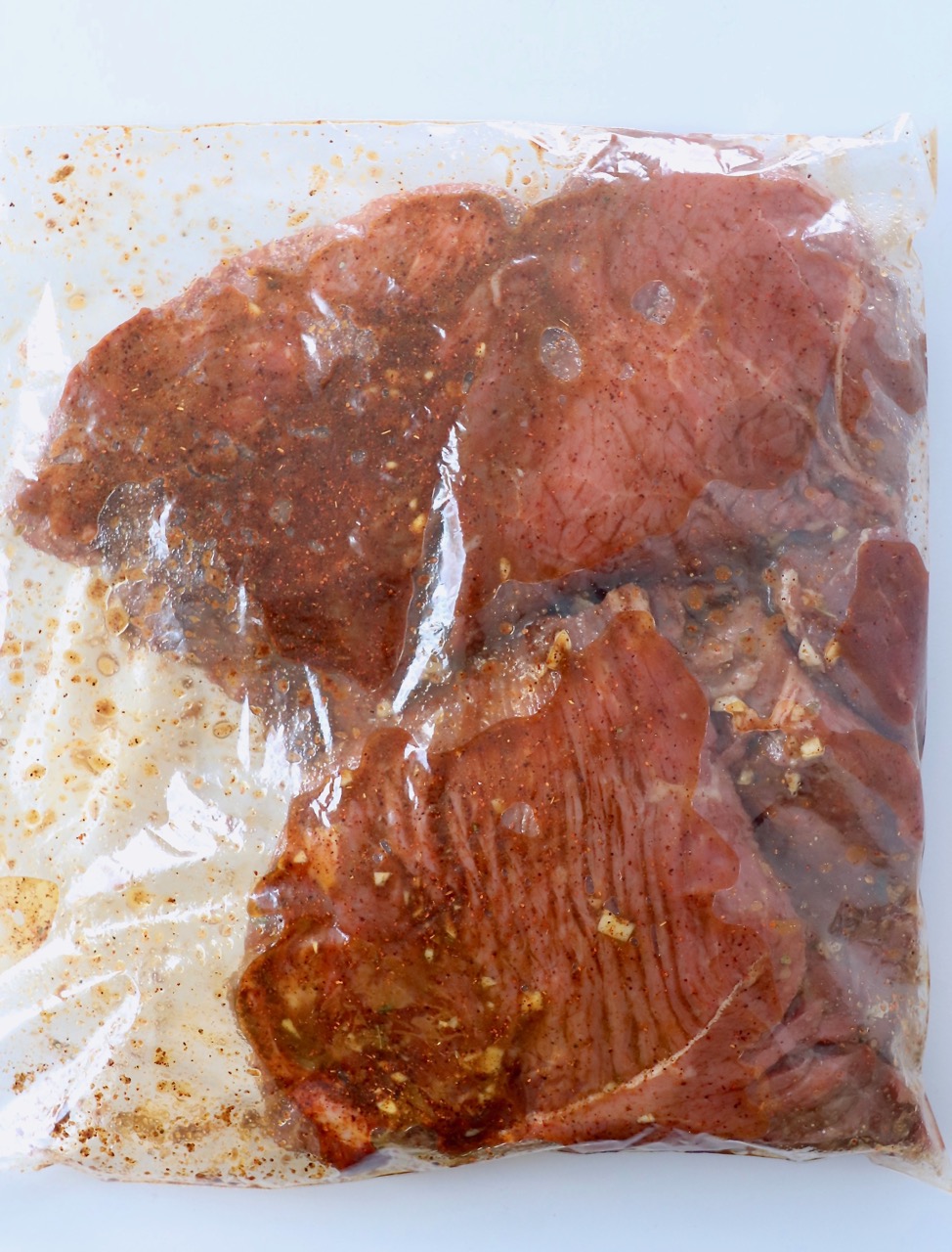 top sirloin steaks in marinade in zipper bag