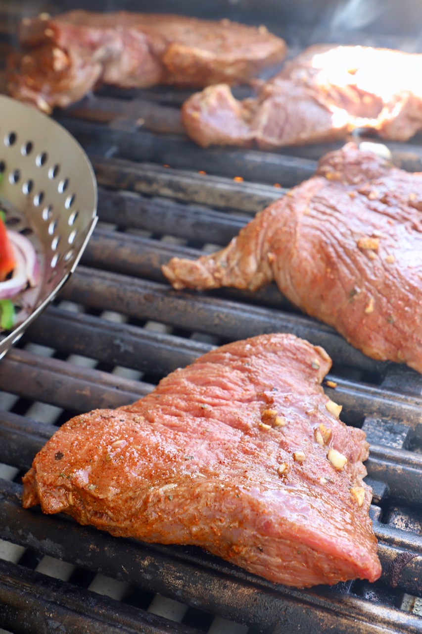 marinated raw steak on grill